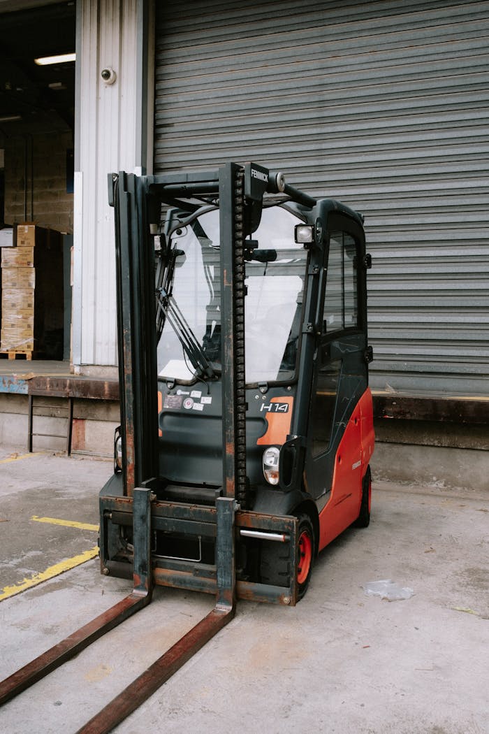 Close-up of a parked forklift in an industrial warehouse dock area.